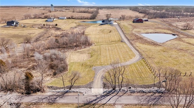 birds eye view of property featuring a rural view and a water view