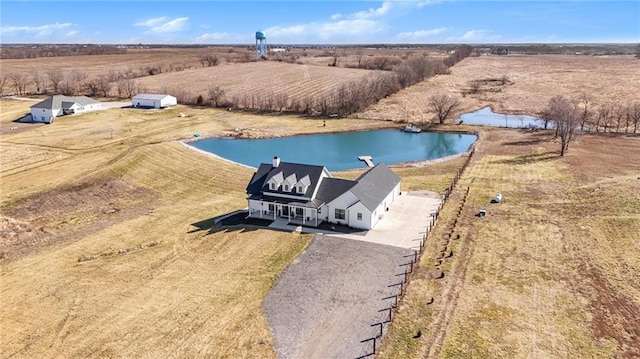 birds eye view of property with a water view and a rural view