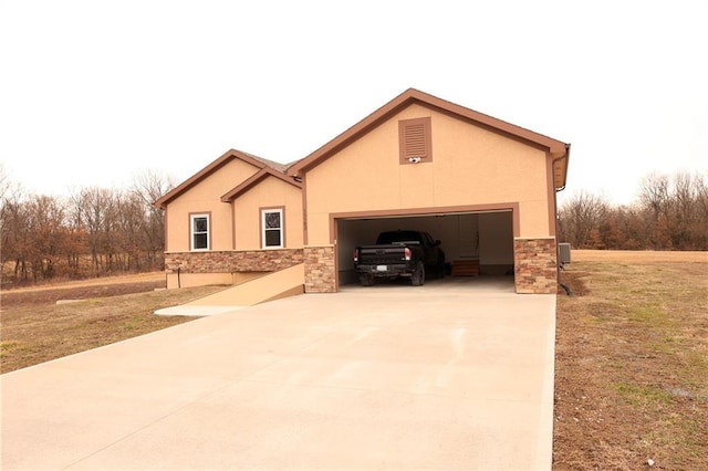 view of front of house with a garage, stone siding, driveway, stucco siding, and a front lawn