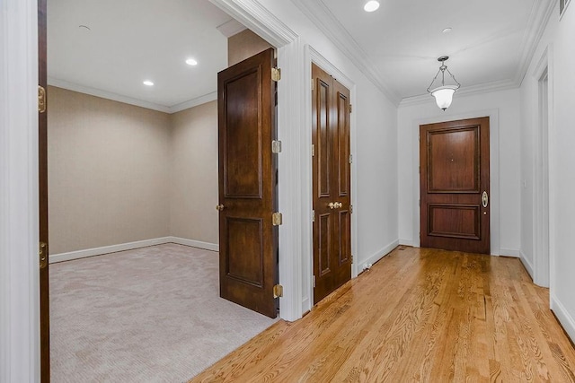 hallway featuring recessed lighting, baseboards, light carpet, and ornamental molding