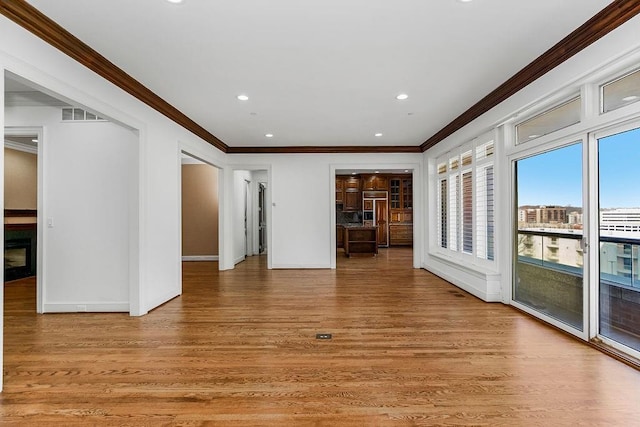 unfurnished room featuring recessed lighting, baseboards, light wood finished floors, and ornamental molding