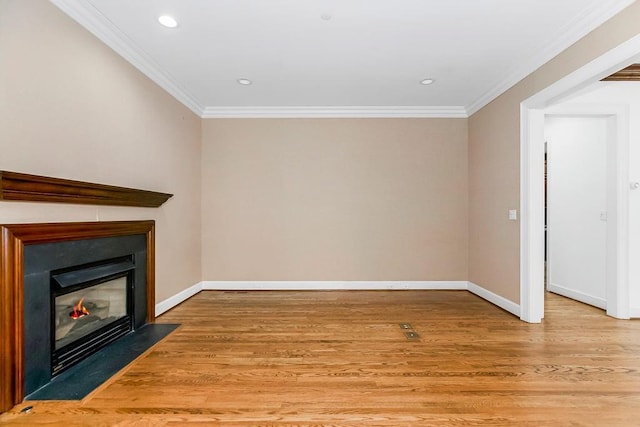 unfurnished living room with light wood finished floors, crown molding, baseboards, a fireplace with flush hearth, and recessed lighting