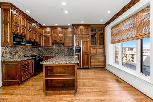 kitchen with black appliances, light wood finished floors, visible vents, and open shelves