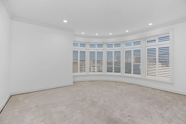 spare room with recessed lighting, crown molding, baseboards, and carpet floors