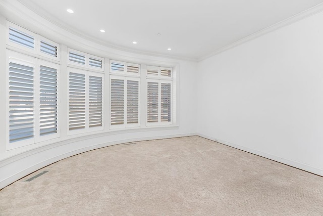 carpeted spare room with recessed lighting, visible vents, plenty of natural light, and crown molding