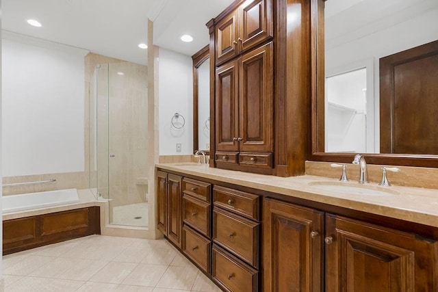 bathroom with tile patterned flooring, a bath, a stall shower, and a sink