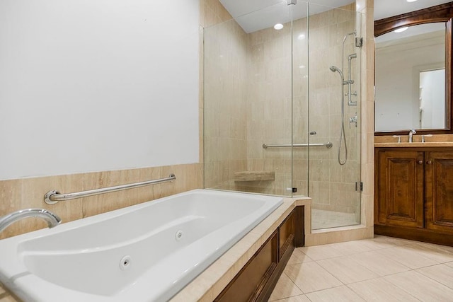 full bathroom with vanity, a stall shower, a whirlpool tub, and tile patterned flooring