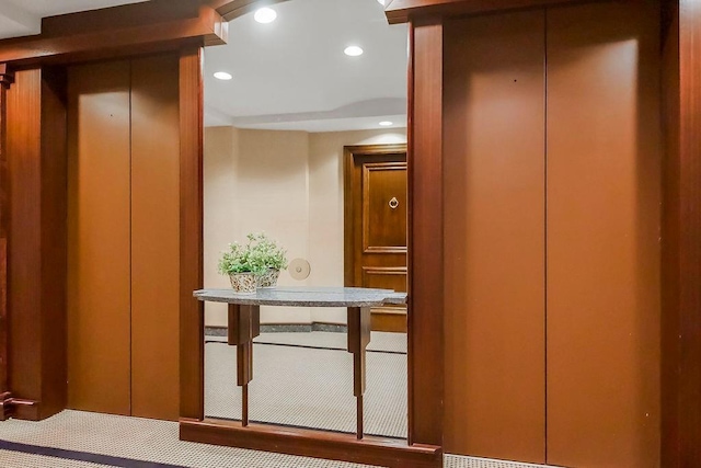 hallway featuring recessed lighting and elevator