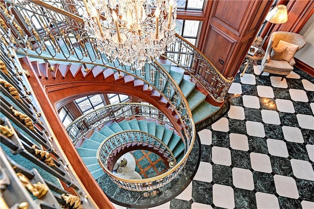 stairs with a chandelier