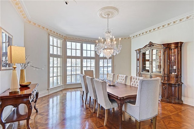 dining room featuring baseboards, a notable chandelier, and ornamental molding