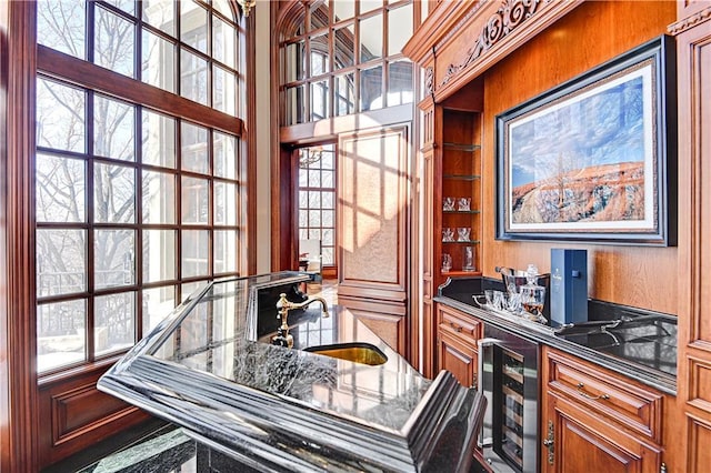 interior space with beverage cooler, indoor wet bar, and a sink