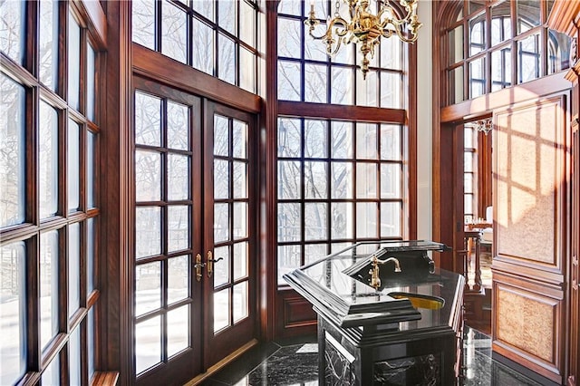 office featuring a high ceiling, a notable chandelier, and french doors