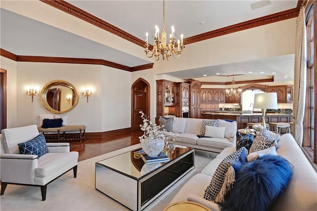 living room with baseboards, a chandelier, arched walkways, and crown molding