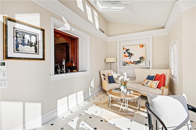 living room with ornamental molding, lofted ceiling, and baseboards