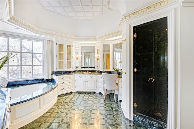 bathroom featuring a wealth of natural light, a shower stall, vanity, and a bath