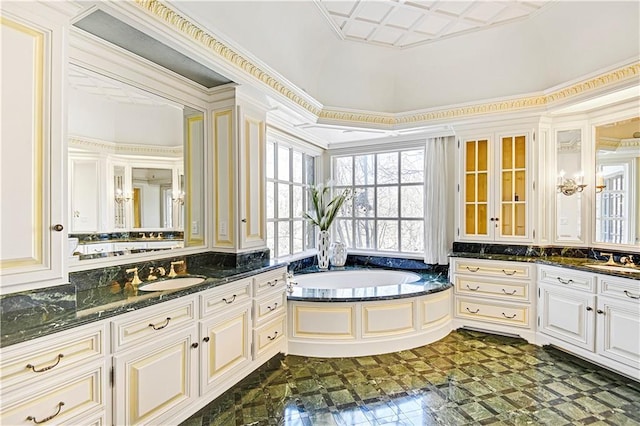 full bathroom with two vanities, a sink, and a bath