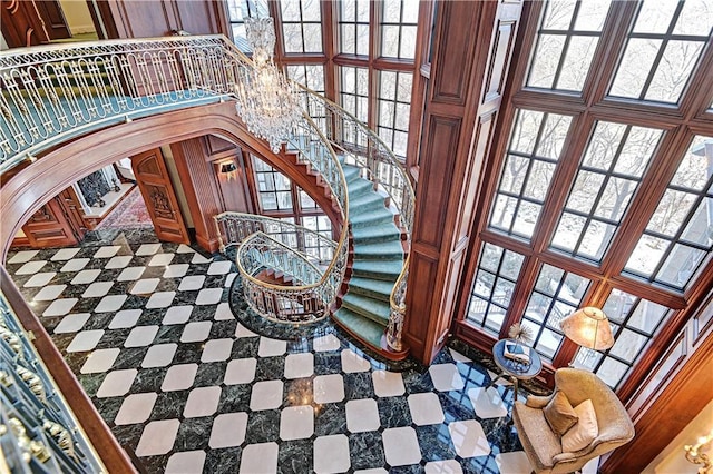 staircase with arched walkways and a high ceiling