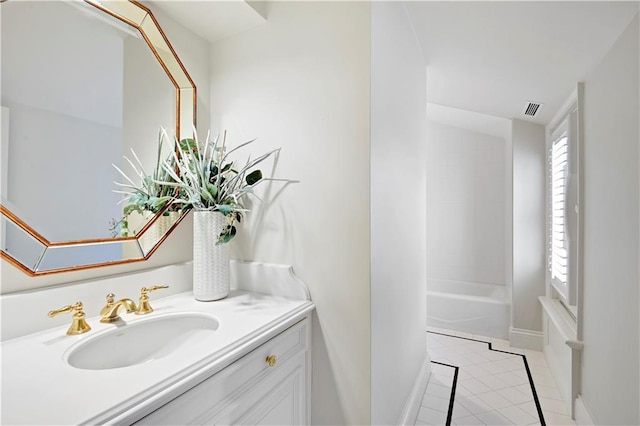 bathroom with baseboards, vanity, visible vents, and tile patterned floors