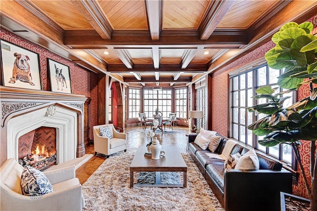 living area with wallpapered walls, wood ceiling, coffered ceiling, and a lit fireplace