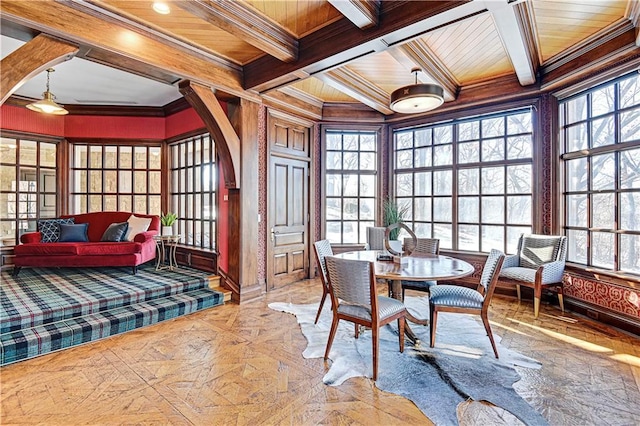 sunroom featuring wooden ceiling, arched walkways, and coffered ceiling