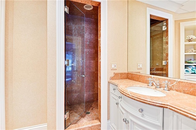 bathroom with a shower stall and vanity