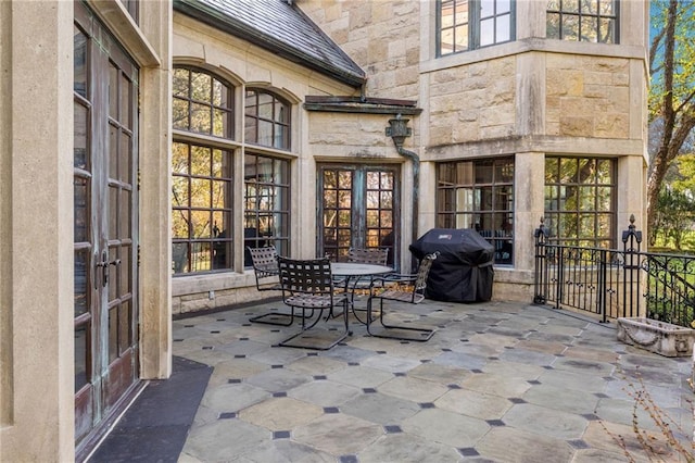 view of patio featuring french doors and a grill