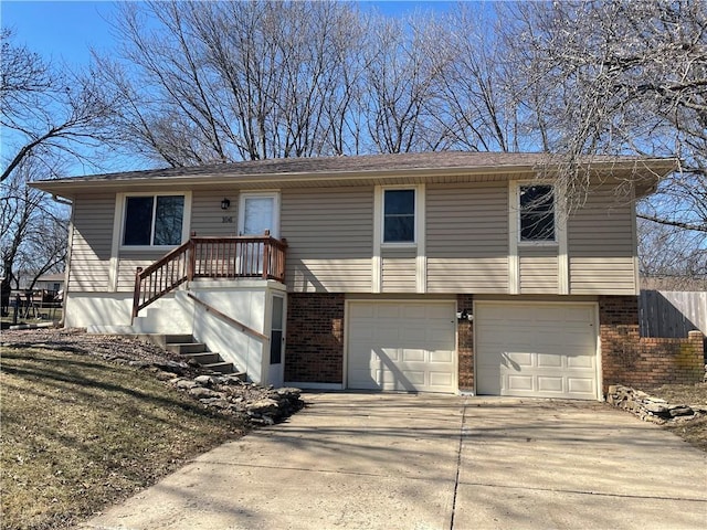 view of front of property featuring brick siding, an attached garage, and concrete driveway