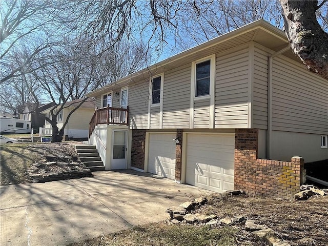 exterior space with driveway, brick siding, and an attached garage