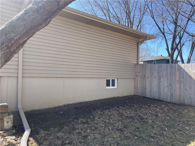 view of side of property featuring fence