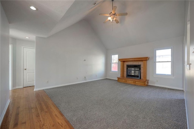 unfurnished living room with a fireplace, lofted ceiling, recessed lighting, a ceiling fan, and baseboards