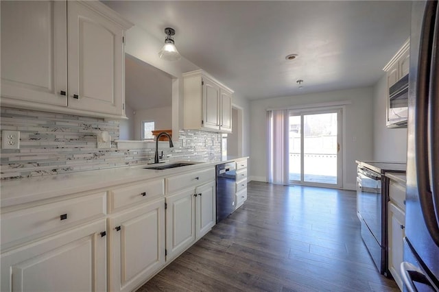 kitchen with a healthy amount of sunlight, white cabinetry, appliances with stainless steel finishes, and a sink