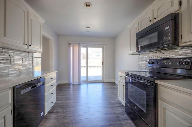 kitchen with dark wood-style floors, black appliances, baseboards, and white cabinets