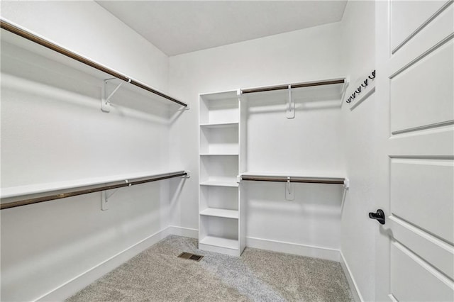 walk in closet featuring carpet floors and visible vents