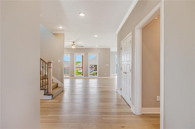7009 NE 103rd St, Kansas City, MO 64156 - hallway with ornamental molding, stairs, light wood-style floors, and recessed lighting