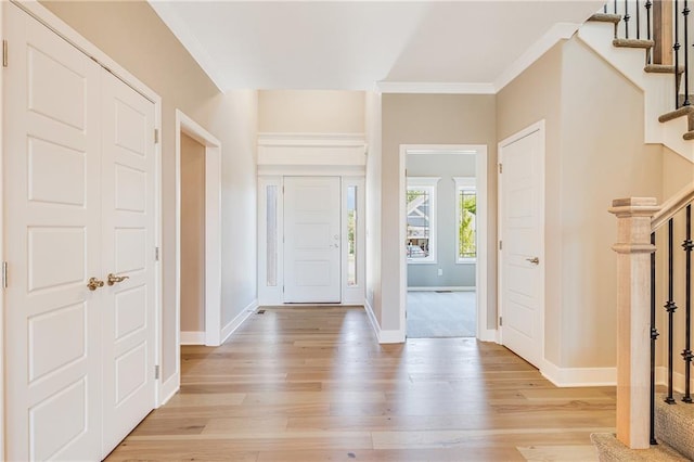 7009 NE 103rd St, Kansas City, MO 64156 - foyer featuring ornamental molding, light wood-type flooring, and stairs