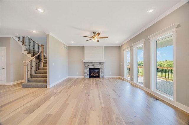 7009 NE 103rd St, Kansas City, MO 64156 - unfurnished living room with light wood-style flooring, crown molding, ceiling fan, recessed lighting, and stairs