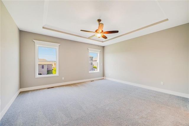 7009 NE 103rd St, Kansas City, MO 64156 - empty room with a tray ceiling, carpet, and a ceiling fan