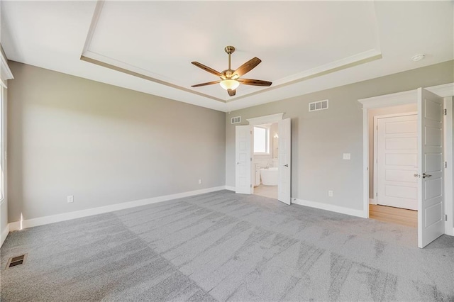 7009 NE 103rd St, Kansas City, MO 64156 - unfurnished bedroom featuring a raised ceiling, carpet floors, and connected bathroom
