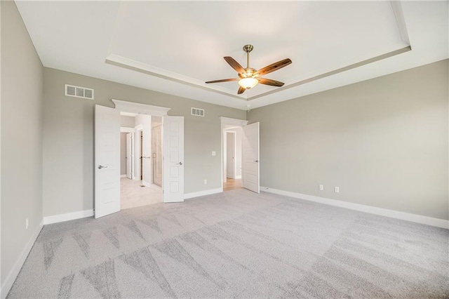 7009 NE 103rd St, Kansas City, MO 64156 - unfurnished bedroom with a raised ceiling, light colored carpet, and a ceiling fan