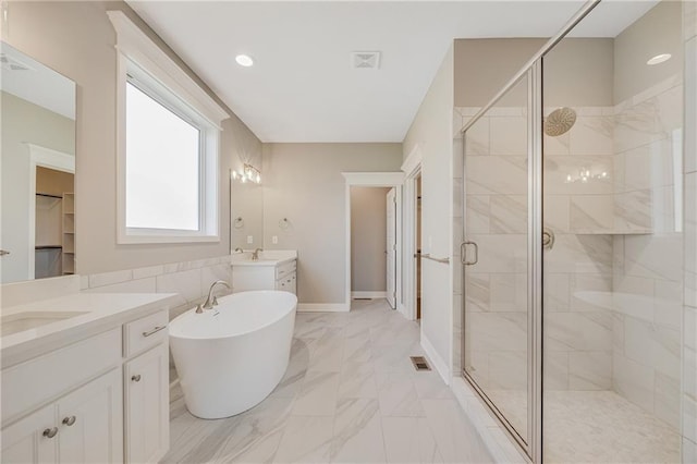7009 NE 103rd St, Kansas City, MO 64156 - full bath featuring a shower stall, two vanities, a soaking tub, and marble finish flooring