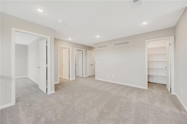 7009 NE 103rd St, Kansas City, MO 64156 - unfurnished bedroom with carpet floors, a walk in closet, and recessed lighting
