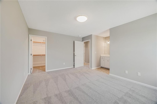 7009 NE 103rd St, Kansas City, MO 64156 - unfurnished bedroom with light carpet, a walk in closet, and ensuite bathroom