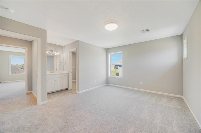 7009 NE 103rd St, Kansas City, MO 64156 - unfurnished bedroom featuring light carpet and ensuite bath