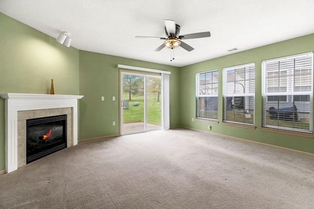 unfurnished living room featuring carpet, a fireplace, and baseboards