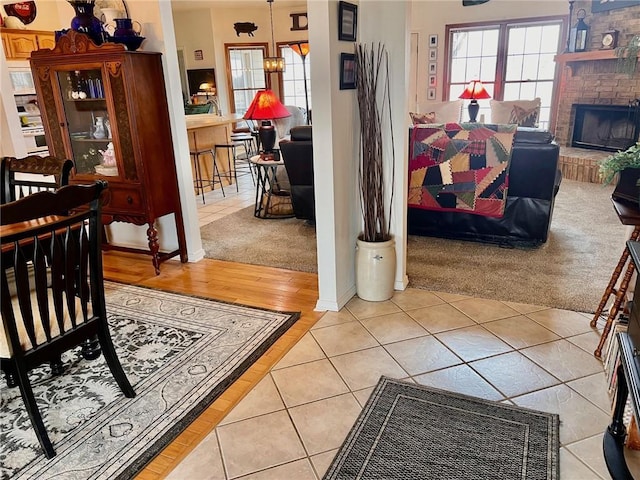 interior space with a brick fireplace and tile patterned floors