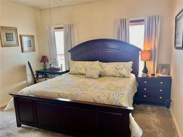 bedroom featuring carpet and baseboards