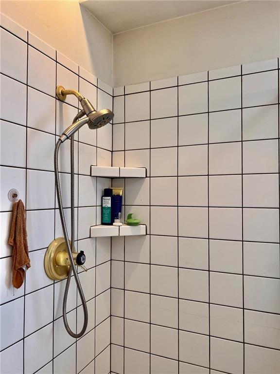 bathroom with tiled shower