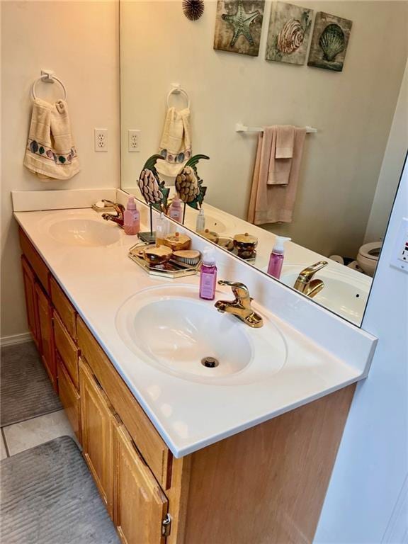 bathroom featuring a sink and double vanity