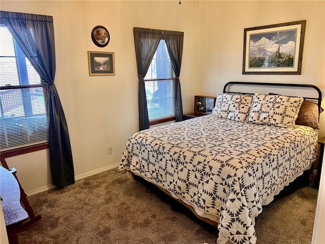 carpeted bedroom featuring baseboards