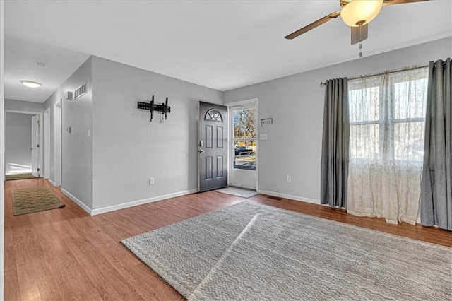 entryway with ceiling fan, wood finished floors, visible vents, and baseboards